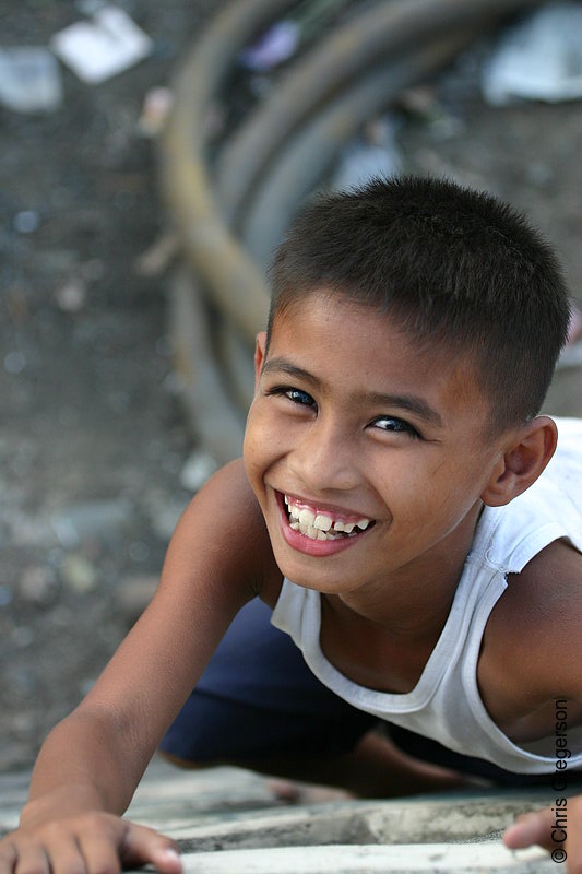 Photo of Young, Smiling Filipino Boy Climbing Wall(4630)