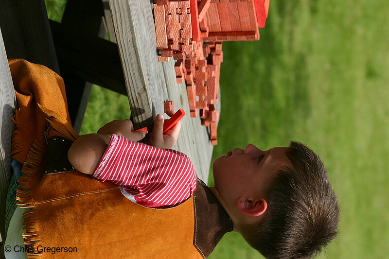 Photo of Young Boy Playing at Picnic Table(4949)