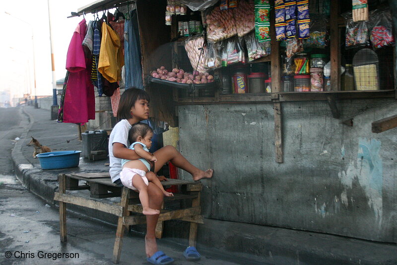 Photo of Sari-Sari Store in Tondo and a Filipina Girl Carrying an Infant(5517)