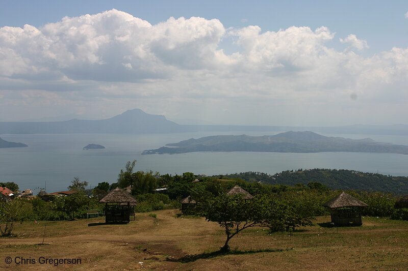 Photo of Taal Volcano Seen Through a Rolling Hill with Nipa Huts(5525)