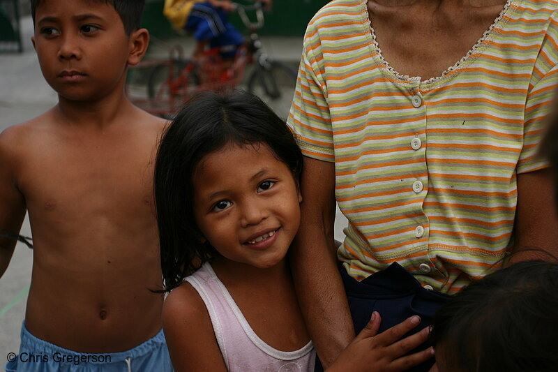 Photo of Smiling Filipina girl Holding onto an Adult(5922)