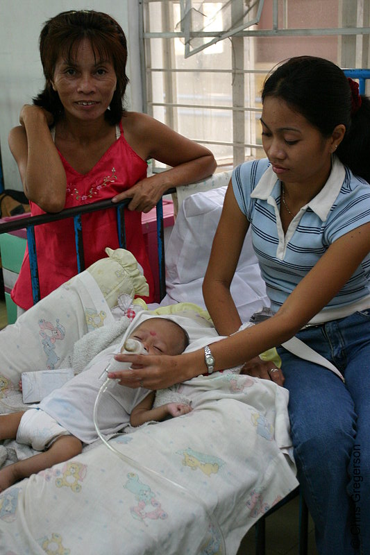 Photo of Mother Assisting Baby with Inhaler in Ospital ng Angeles' (ONA) Nursery (5957)