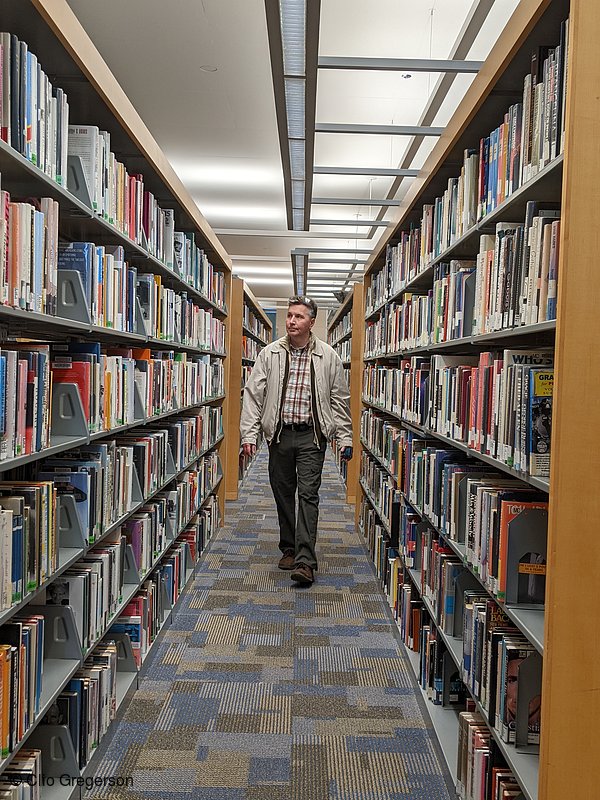 Photo of Chris Walking Through a Library(8421)