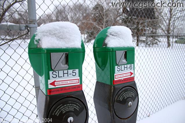 snow,park,parking,winter,meters,green,red,white,tennis court,parking lot,icy,cold,fence