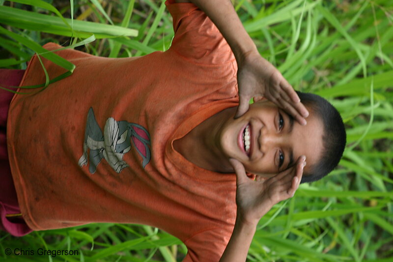 Photo of A Boy in the Weeds, Looking up and Smiling(4864)