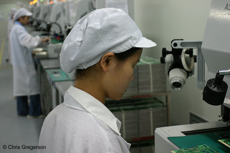 Photo of Row of Workers Inspecting Electronics(4904)