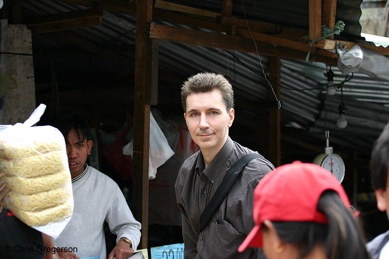 Photo of Chris In Front of a Rice Grain Vendor in Baguio Public Market(5757)