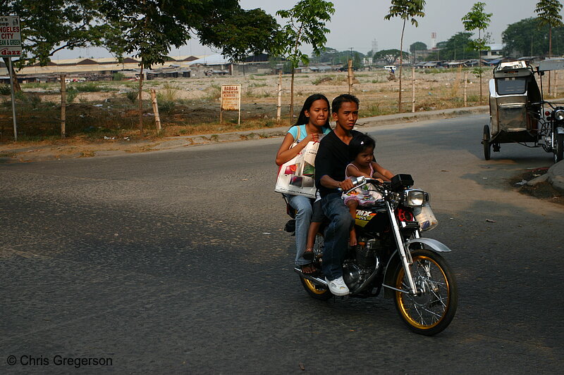 Photo of Filipino Family Riding a Motorcycle near Ospital ng Angeles, Angeles City(5924)
