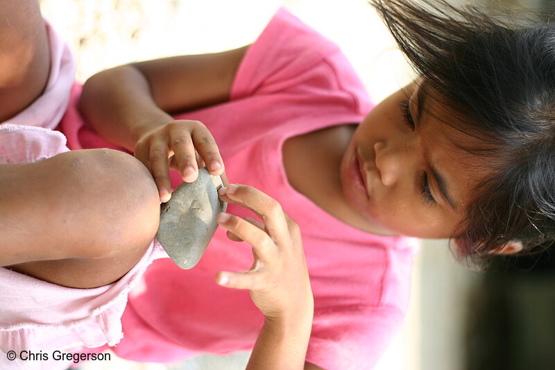 Photo of Pre-School Girl Playing with a Rock, the Philippines(6334)