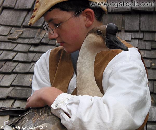 Teenage Boy in Costume Holding a Goose