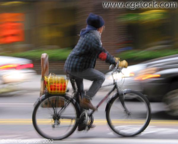 Bicyclist Commuter in Downtown Traffic