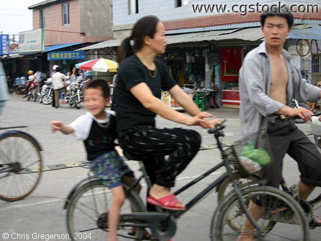 Woman and Boy on Bicycle
