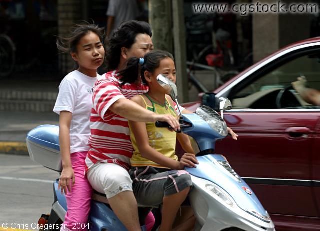Woman on a Moped with Girls, Shanghai