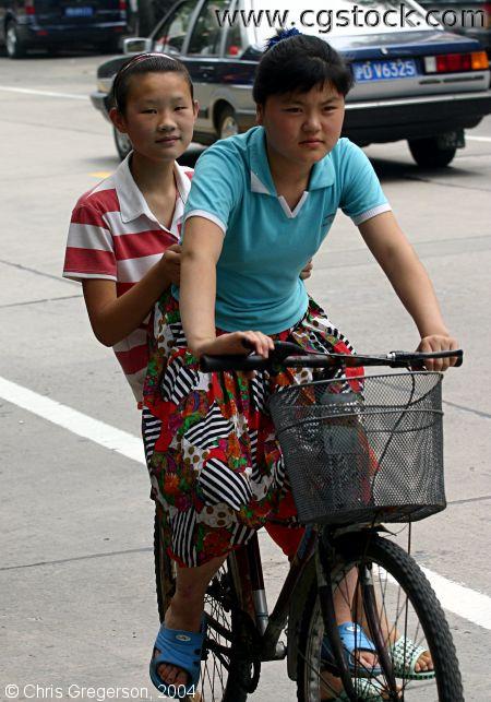 Girls Sharing a Bike