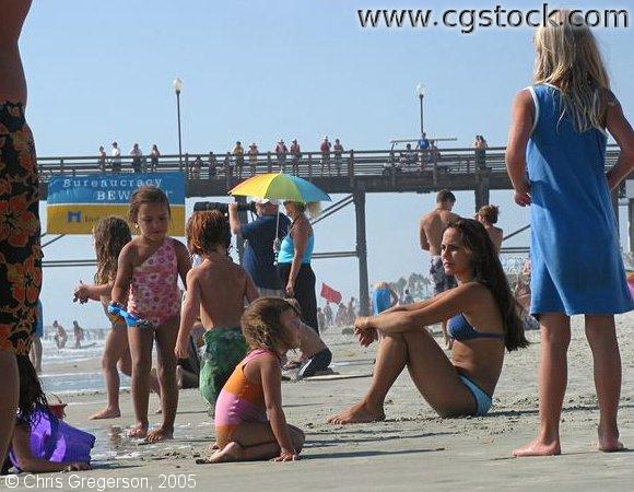 Woman and Kids on Crowded Beach, Oceanside