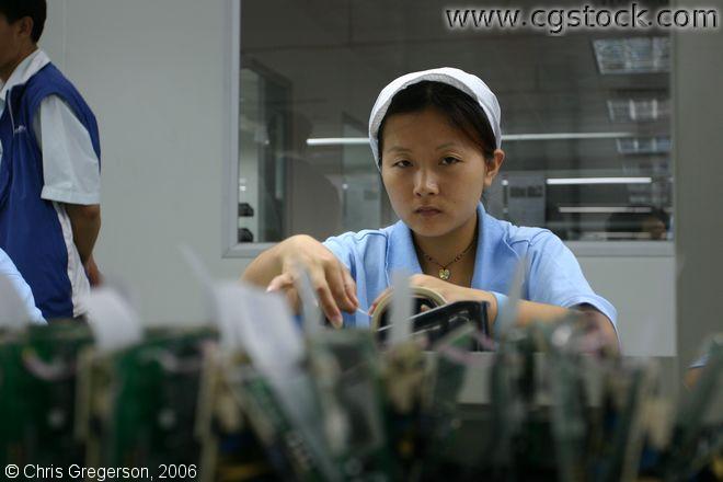 Young Woman Working in Electronics Factory