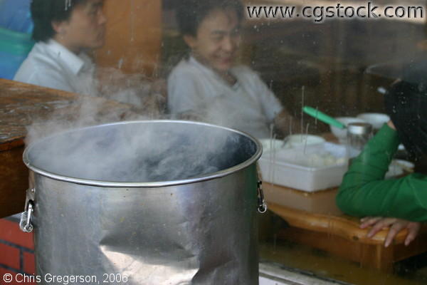 Steaming Pot and Diners in a Chinese Restaurant