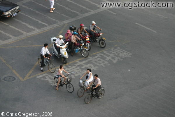 Scooters, Motorcycles, and Bicycles at an Intersection in China