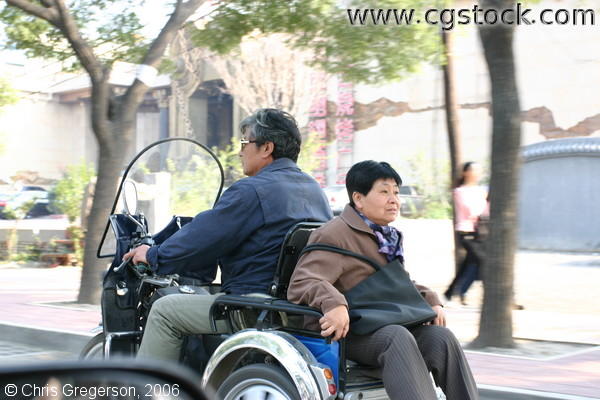 Old Chinese Couple on Motorized Cart