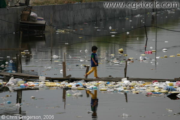 Boy Crossing a Polluted River in Baclaran, Manila