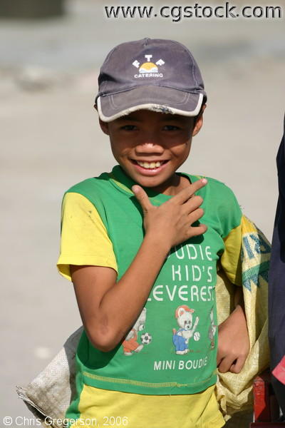 Boy Flaunting His Face Wearing a Green Shirt
