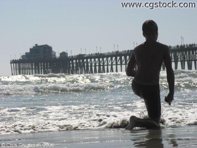 Boy Kneeling on the Beach, Oceanside
