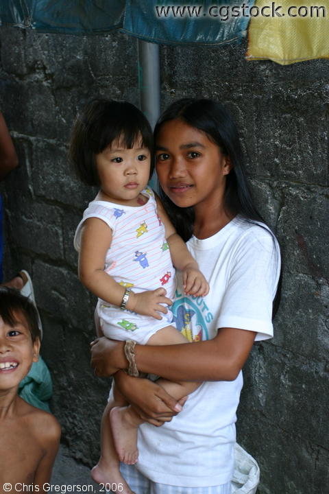 A Young Filipina Lady Carrying a Child