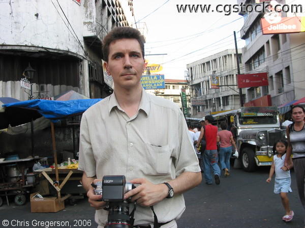 A Foreign Photographer Searches for the a Good Shot in Quiapo