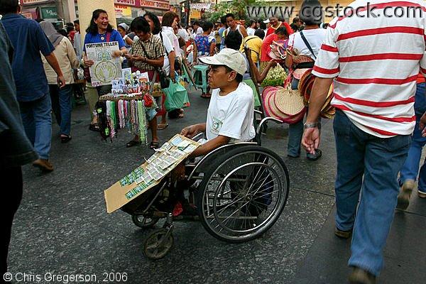 Disabled Man in a Wheelchair selling Sweepstakes Tickets near Quiapo Church