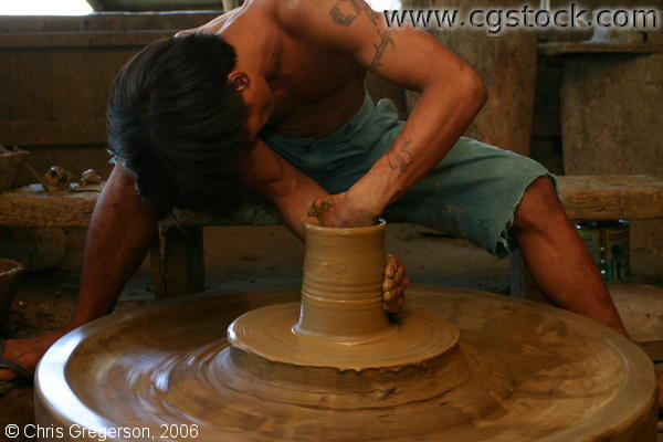 Craftworker Sculpting a Pot Using His Hand