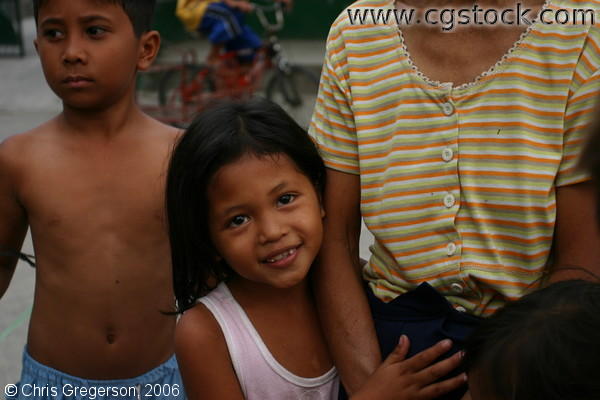 Smiling Filipina girl Holding onto an Adult