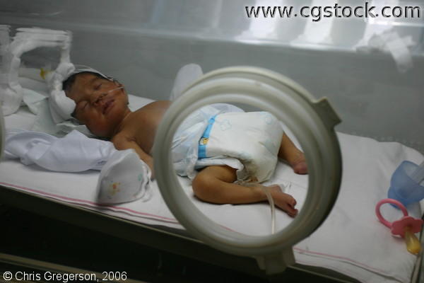 Premature Child Sleeping inside Isolette in the Philippines