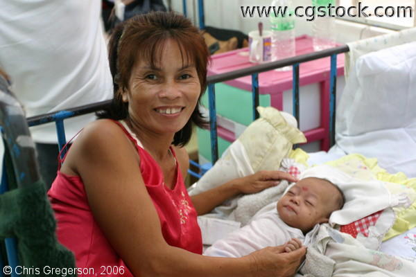 Smiling Grandmother Posing Beside a Sleeping Baby in the Nursery 