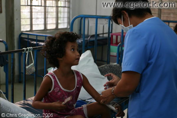 Nurse Giving Injection to Young Patient at ONA