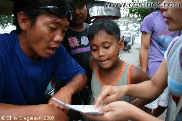 Tricyle Drivers and Local Residents Browsing a Map of Angeles City, Pampanga