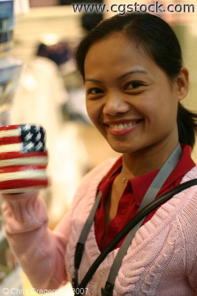 Woman Smiling with an American Flag Coffee Cup at a gift shop in Washington D.C.