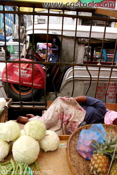 Produce Vendor Sleeps in Traffic, Manila, Philippines.