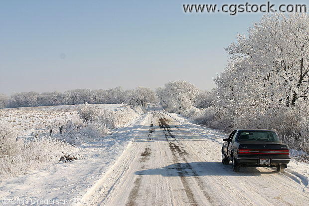 Car Along Rural Road in Wintertime