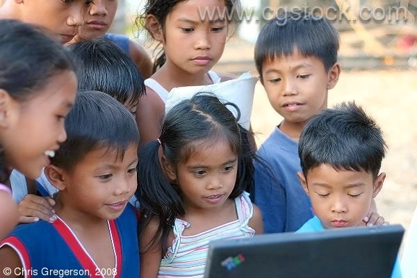 Children Gathered Around a Laptop Computer in the Rural Philippines