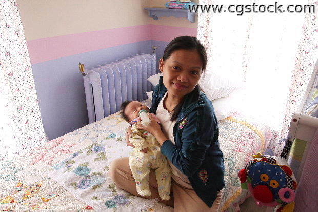Mom Feeding Newborn in Nursery