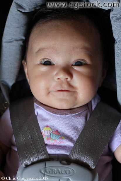 Young Baby in a Carseat Smiling