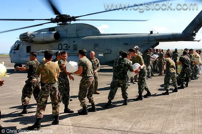 US and Philippine Soldiers Loading Helicopter with Relief Supplies