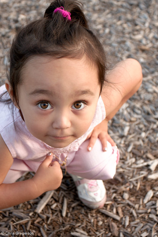 Girl Crouching Down at the Playground